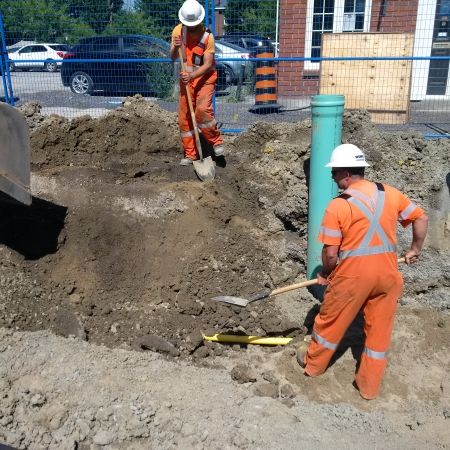 Construction working digging beside gas pipe