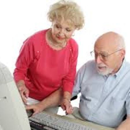 Elderly couple looking at a computer monitor